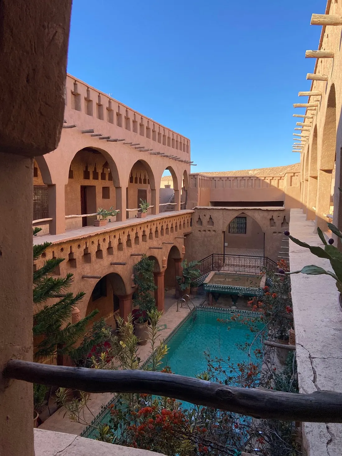 Valentina Turano at a Moroccan riad courtyard with a turquoise pool