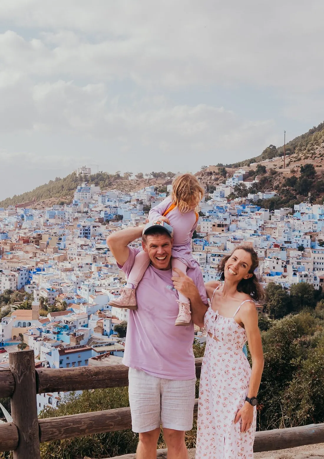 Family at the Chefchaouen panorama viewpoint, blue city behind