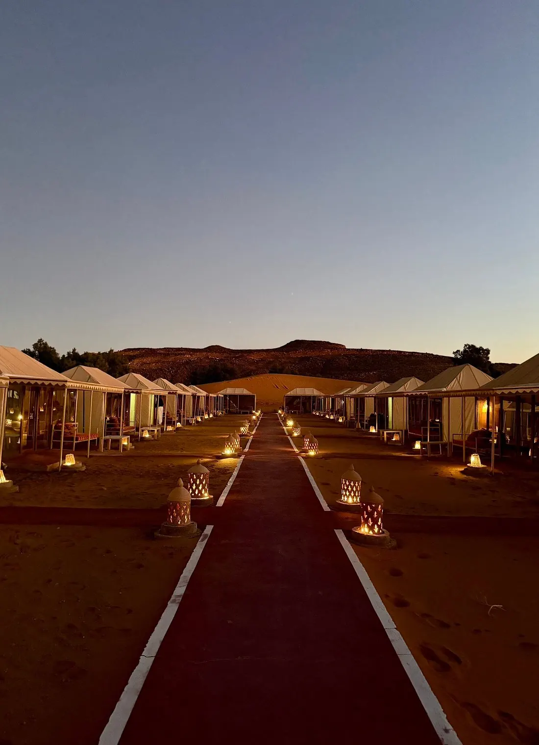Luxury Berber desert camp lit at night