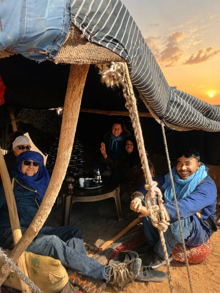 Traditional Berber tent welcome with mint tea at sunset in the desert