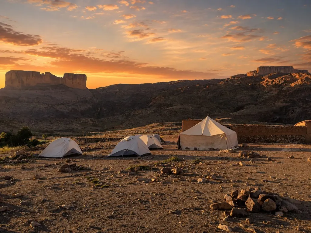 Berber trekking camp at the foot of a flat-topped mesa at sunset