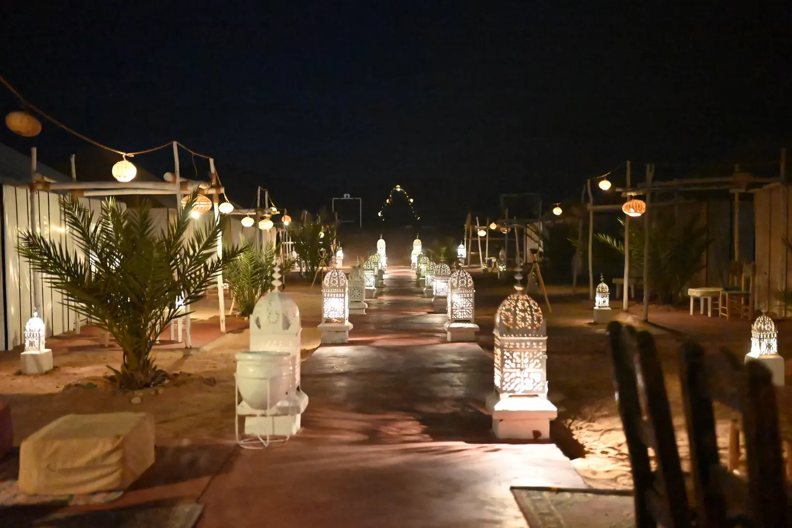 Luxury desert camp lit with lanterns at night