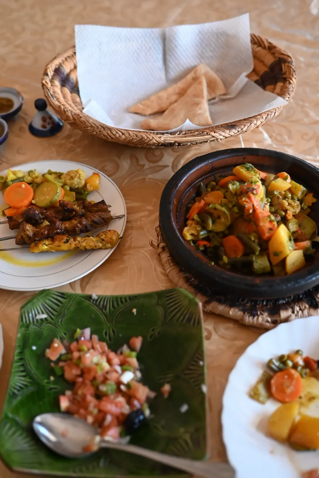 Traditional Moroccan lunch spread with tajine and salads