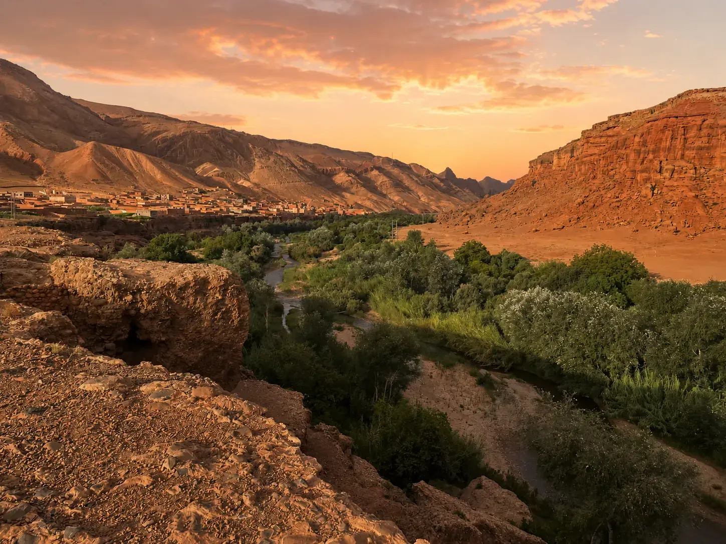 The Dadès Valley gorge at golden hour, winding road between terracotta canyon walls