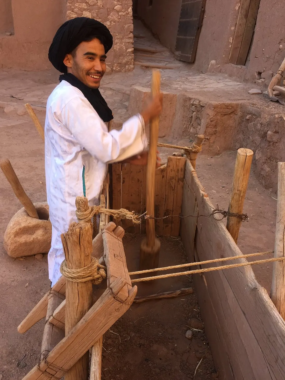 Local craftsman working with traditional tools inside the kasbah walls