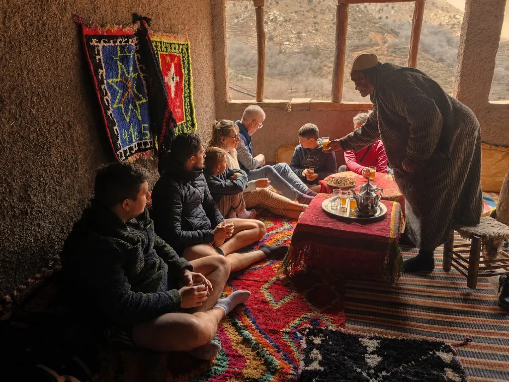 Mint tea being poured during a welcome in a Berber family home