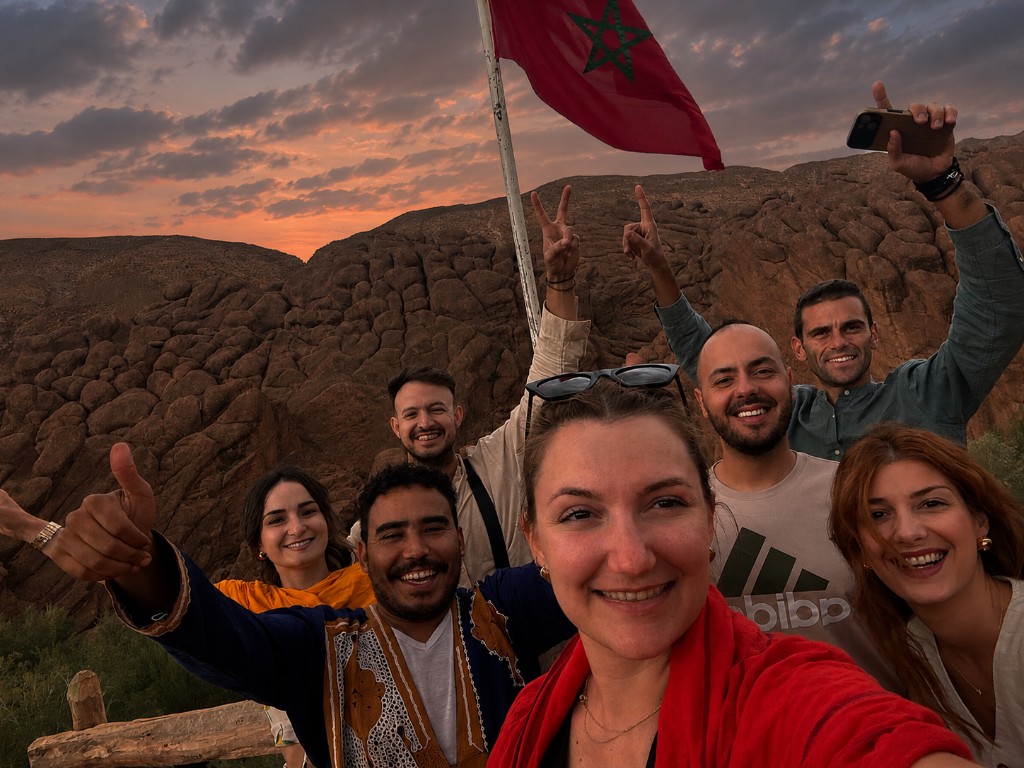 Group of travellers with Ahmed at sunset in the Dades Valley, Morocco